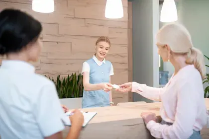 Woman Paying at Dental Office