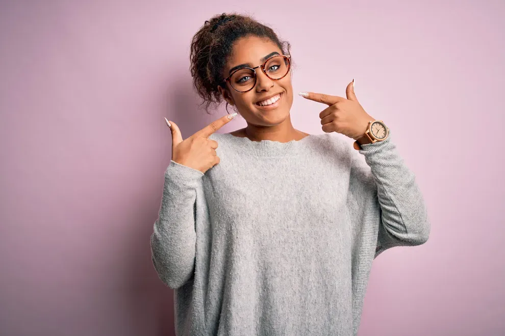 woman-smiling-pointing-at-mouth